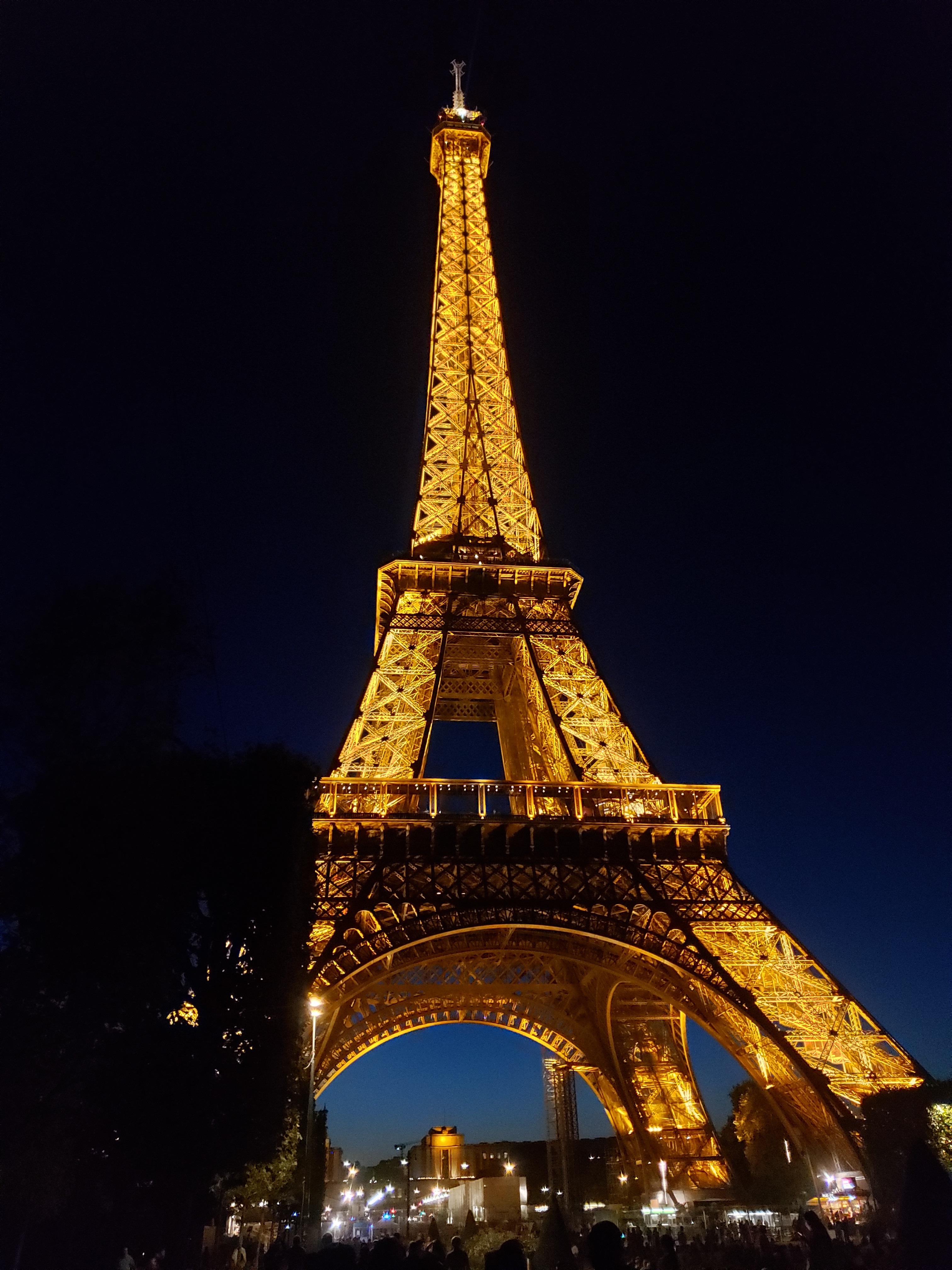 Eiffel Tower at night. Light up with a golden light, black sky in the background