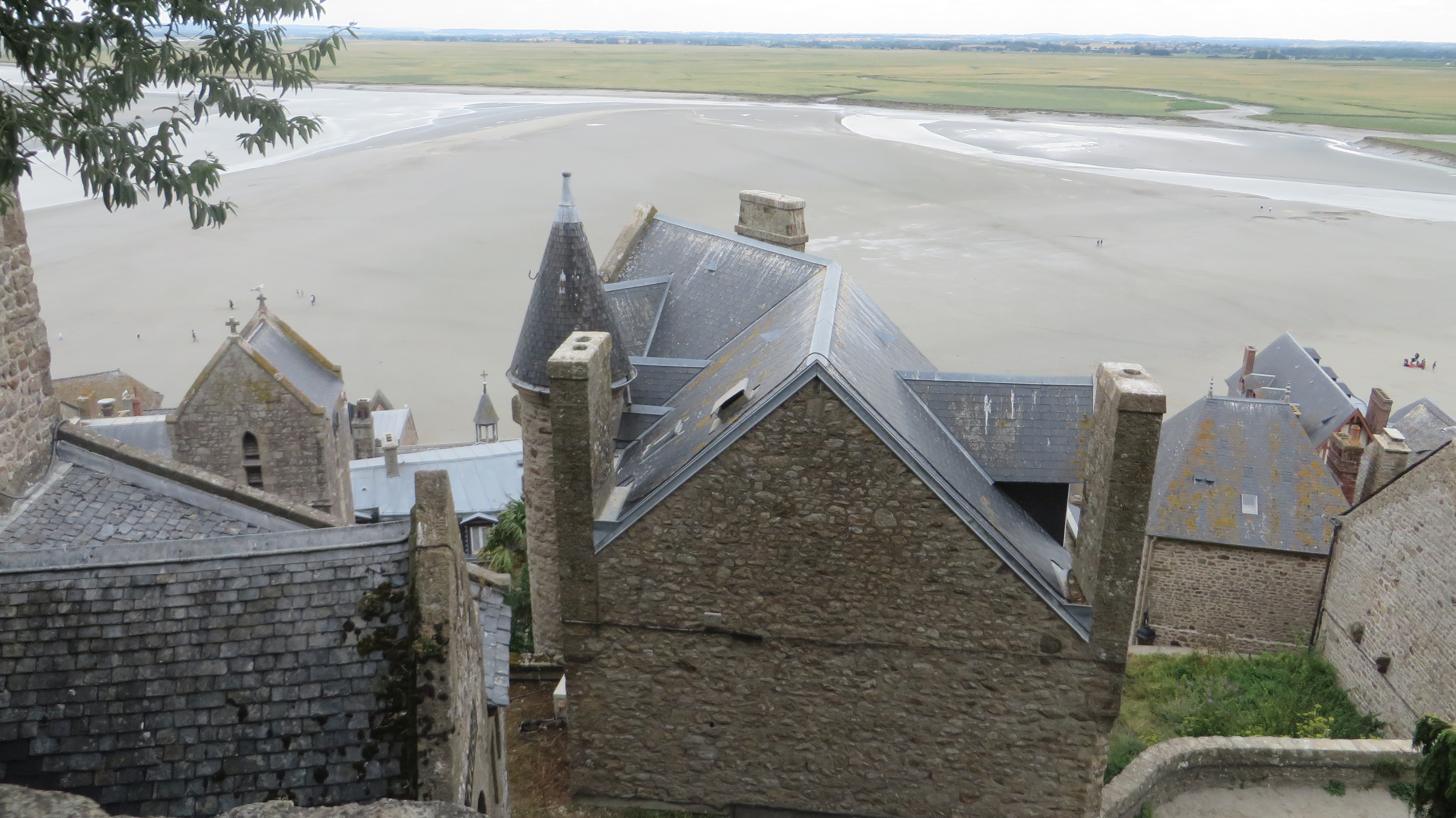 View of the building, the beach, and the ground beyond.