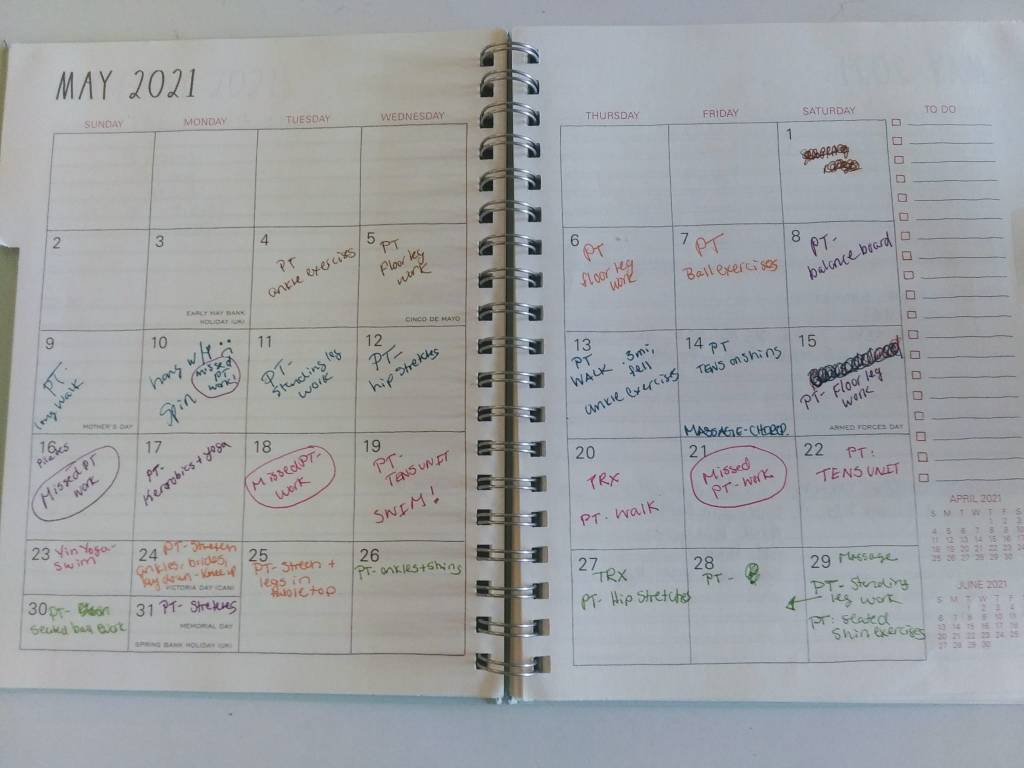 Kerry's planner opened to the May 2021  month calendar page.  There are notes on each day indicating what activity was performed, or not performed
