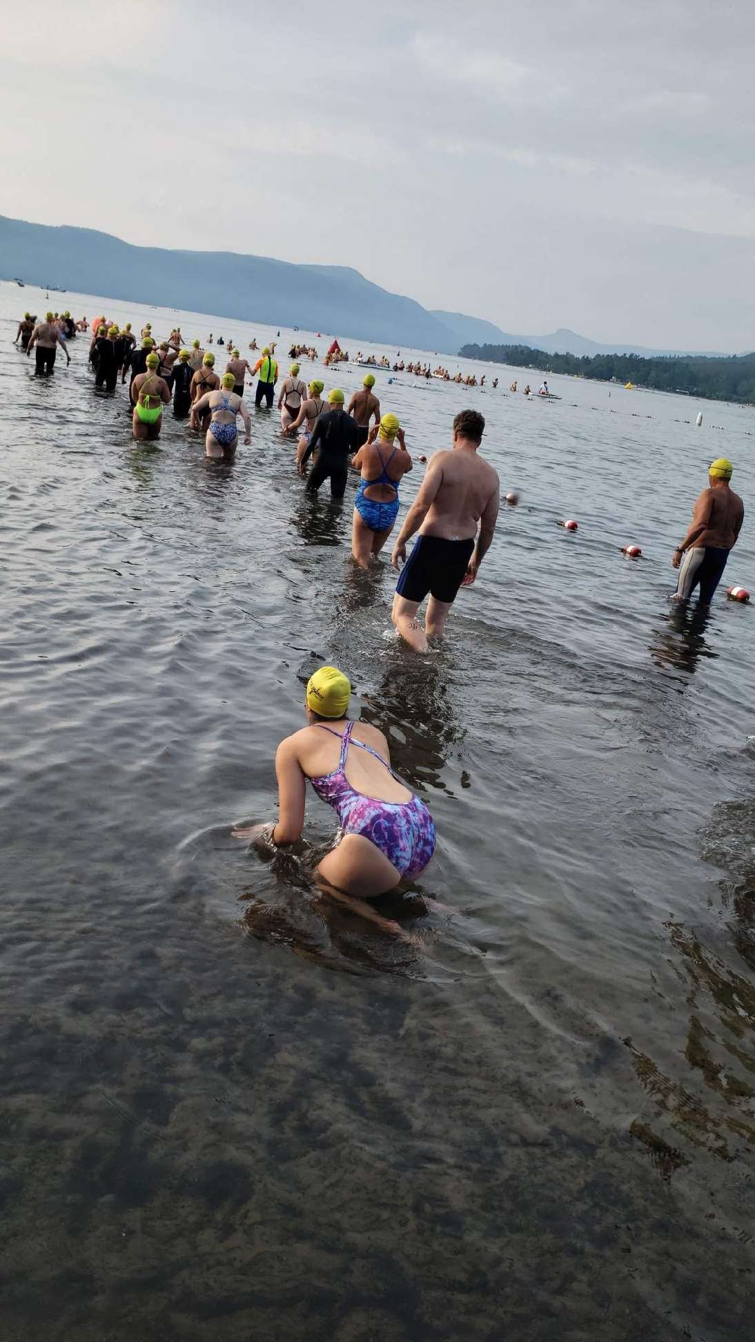 In the foreground is Kerry on all fours crawling into the water with a line of swimmers walking into the water